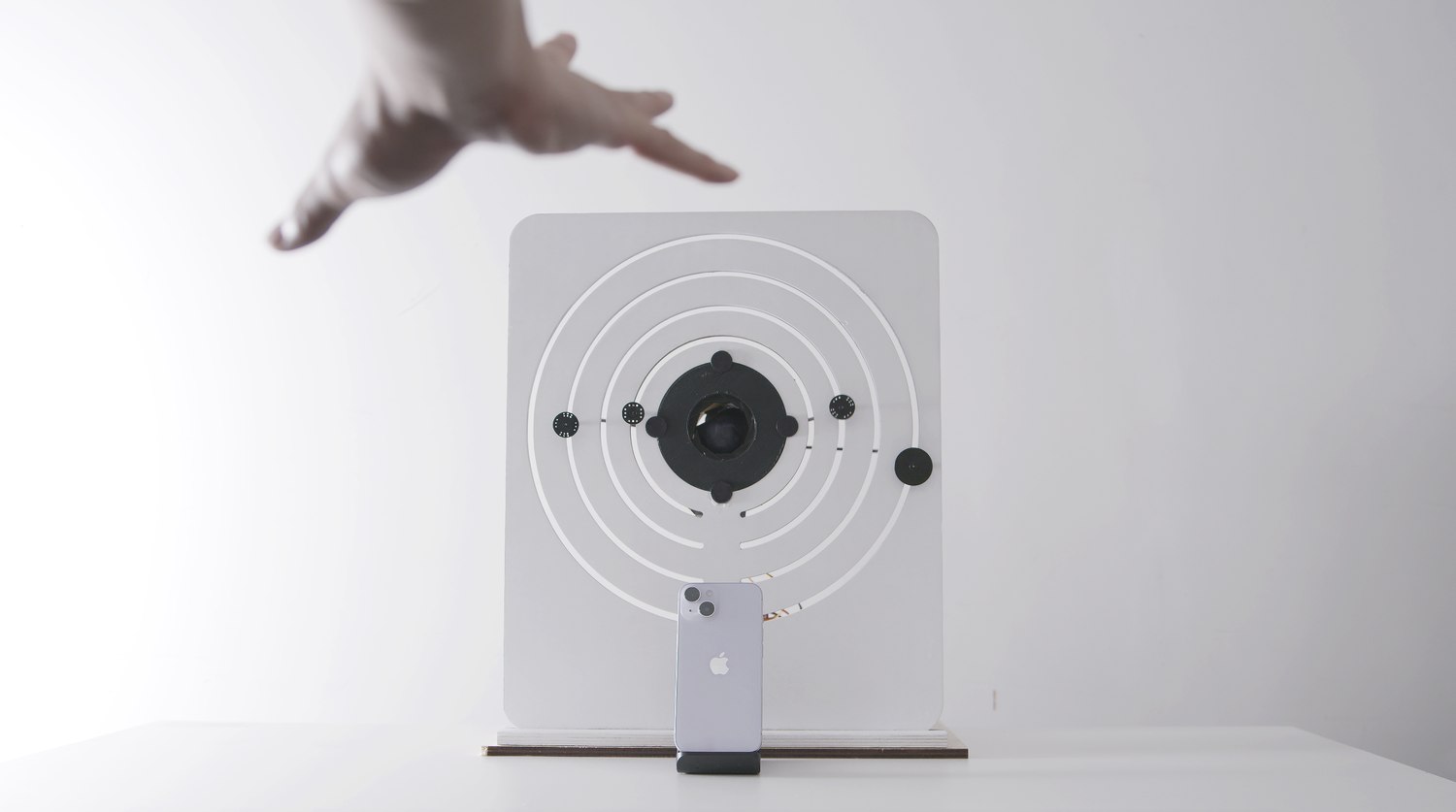 An open palm held above the device, the gesture that commits the sequence