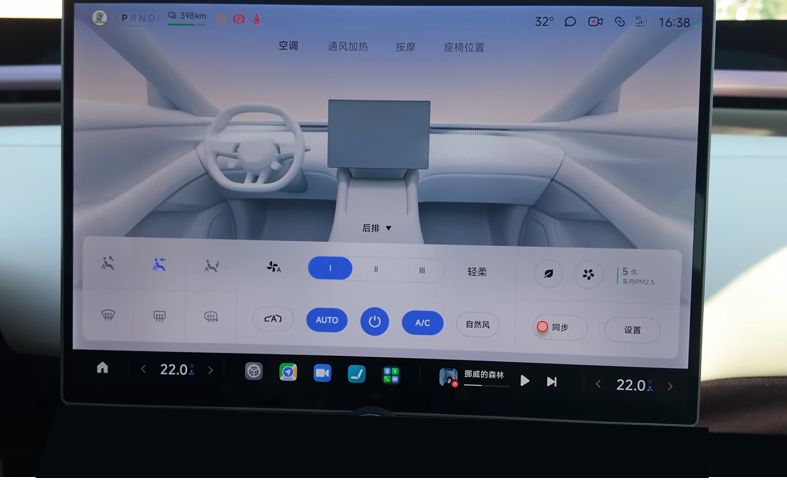 The centre screen with the climate panel open across its lower half, over the drive view: seat heating, fan speed, AUTO, A slash C, sync and air quality spread along it